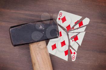 Hammer with a broken card, vintage look, eight of diamonds