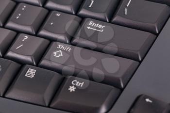 Closeup of the keys on a black colored computer keyboard