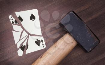 Hammer with a broken card, vintage look, four of spades