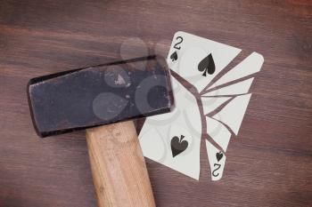 Hammer with a broken card, vintage look, two of spades