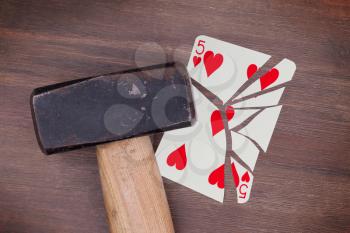 Hammer with a broken card, vintage look, five of hearts