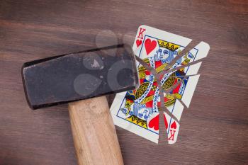 Hammer with a broken card, vintage look, king of hearts