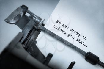 Vintage inscription made by old typewriter, We are sorry to inform you that