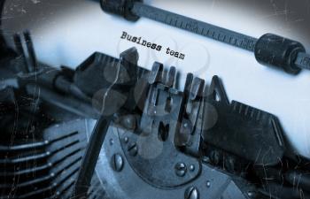 Close-up of an old typewriter with paper, perspective, selective focus, business team