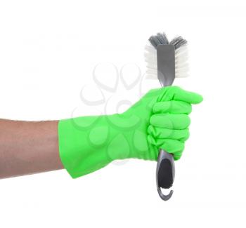 Hand with a protection glove holding a dish-brush