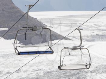 Empty ski lift above snow, mountains in Switzerland
