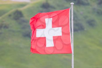 Flag of Switzerland, mountain view in the background