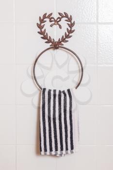 Ring shaped towel holder with towel, white wall