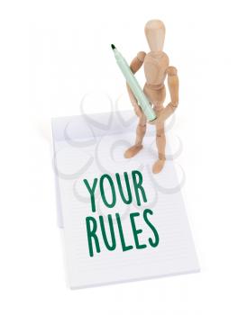 Wooden mannequin writing in a scrapbook - Your rules