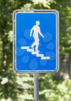 Blue roadsign in Switzerland, old and worn, stairs