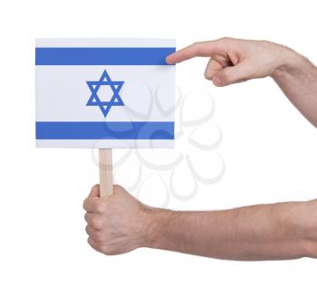 Hand holding small card, isolated on white - Flag of Israel