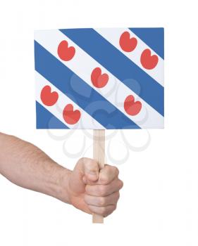 Hand holding small card, isolated on white - Flag of Friesland