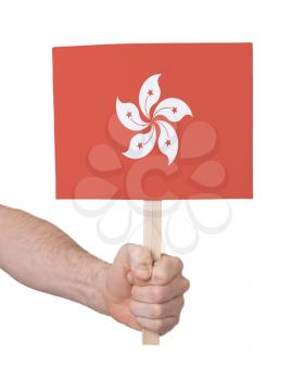 Hand holding small card, isolated on white - Flag of Hong Kong