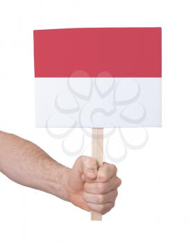 Hand holding small card, isolated on white - Flag of Indonesia