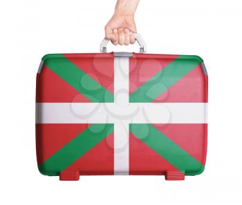 Used plastic suitcase with stains and scratches, printed with flag - Basque Country
