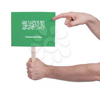 Hand holding small card, isolated on white - Flag of Saudi Arabia