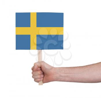Hand holding small card, isolated on white - Flag of Sweden