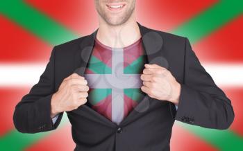 Businessman opening suit to reveal shirt with flag, Basque Country