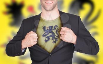Businessman opening suit to reveal shirt with flag, Flanders
