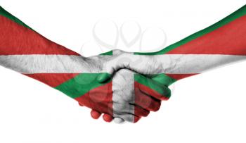 Man and woman shaking hands, wrapped in flag pattern, Basque Country
