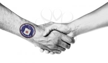 Man and woman shaking hands, wrapped in flag pattern, CIA