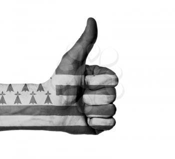 Closeup of male hand showing thumbs up sign, flag of Brittany