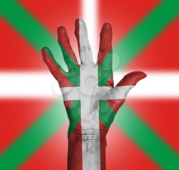 Palm of a woman hand, painted with flag of Basque Country