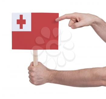 Hand holding small card, isolated on white - Flag of Tonga