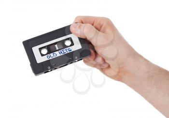 Vintage audio cassette tape, isolated on white background, old hits