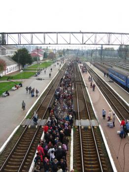 View to the people waiting for the electric train in the railway station
