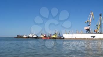 panorama of the sea port with docks and hoisting cranes