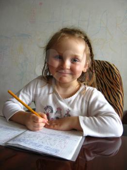little girl with nice hair-do learning her  home tasks