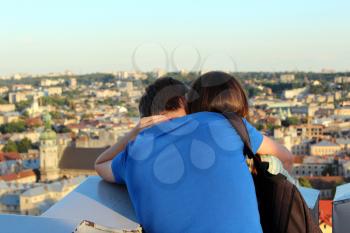 Pair of young enamoured people on a background of house-tops of Lvov