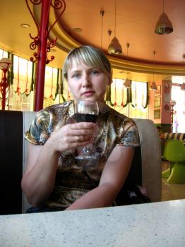 women with glass of red wine in restaurant