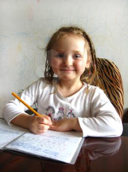 the little girl with nice hair-do learning her  home tasks