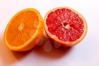 image of orange and  grapefruit divided in half