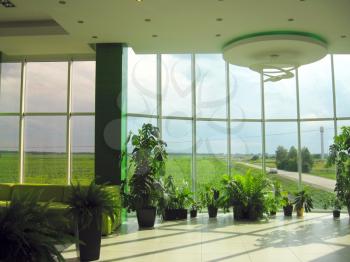 window of the office with view to green field