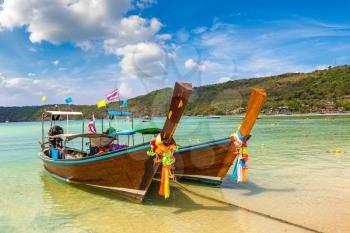Traditional thai longtail boat at Log Dalum Beach on Phi Phi Don island, Thailand in a summer day