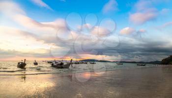 Panorama of Traditional long tail boat at sunset on Ao Nang beach, Thailand in a summer day