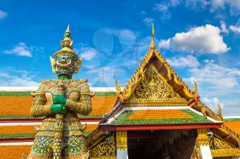 Demon Guardian in Wat Phra Kaew (Temple of the Emerald Buddha), Grand Palace in Bangkok in a summer day