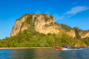 Traditional long tail boat at sunset on Ao Nang beach, Krabi, Thailand in a summer day