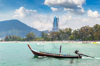 Traditional long tail boat on Patong beach and Andaman sea on Phuket in Thailand in a summer day