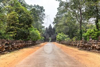 Row of sculptures in the Gate of in complex Angkor Wat in Siem Reap, Cambodia in a summer day