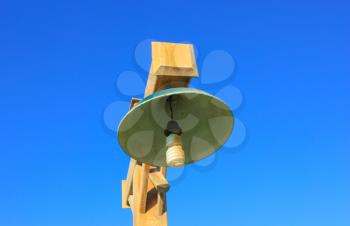 Wooden striit lamp on blue sky background
