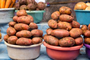 Two pails of potatoes on market counter
