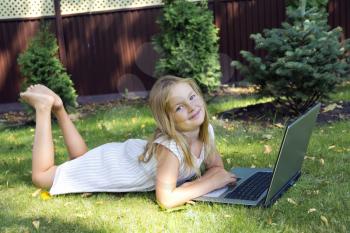 Image of cute girl with laptop in summer