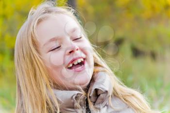 Autumn portrait of laugh girl in sunlight