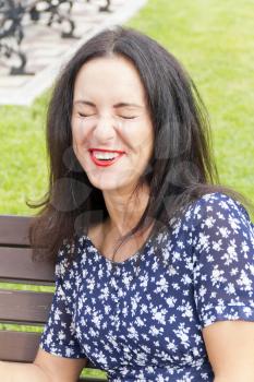 Portrait smiling brunette with red lipstick in summer