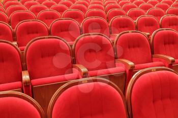Background of many red theatrical red chairs