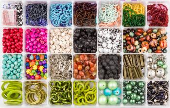 Multicolored assorted beads set in a box. Hand made jewelry. Abstract background. 